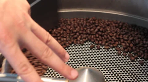 Java, human hand helps explain the coffee roasting process  (HD) Stock Footage 37255988