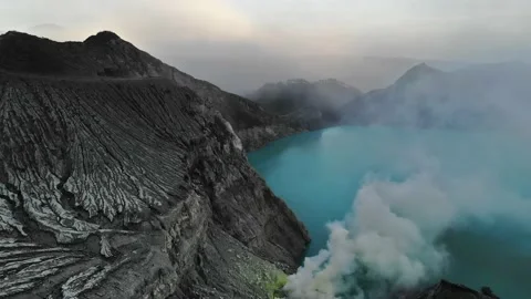Java Ijen mountain volcano sulfur lake turquoise blue color with smoke drone 4k Stock Footage 150499166