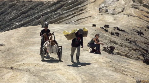 JAVA, INDONESIA - Ijen volcano, worker carrying heavy basket w Stock Footage 59855781