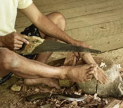 Java, Indonesia, June 13, 2022 - Man carves Tau Tau which are wooden effigies Stock Photos