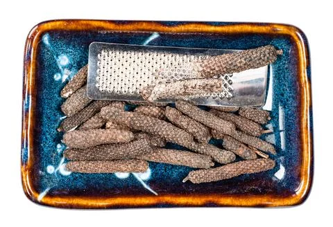 Java long pepper and grater in ceramic bowl cutout Photos