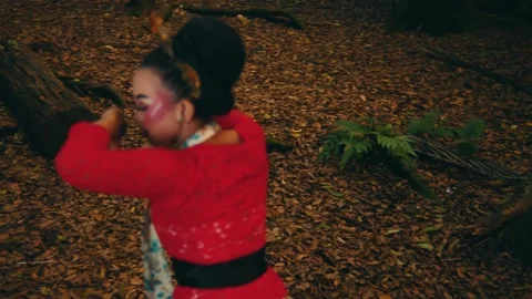 Javanese Dancer in Red Kebaya Performing Elegant Spins in Forest Stock Footage 263949367