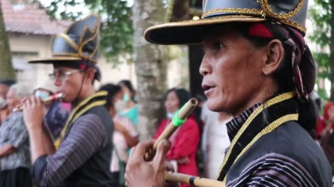 A Javanese man plays the flute during a cultural festival in Yogyakarta Stock Footage 244611782