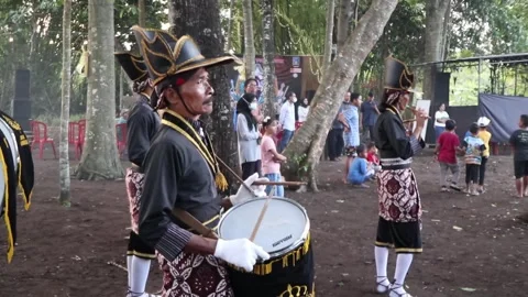 A Javanese man plays the flute during a cultural festival Stock Footage 244611858