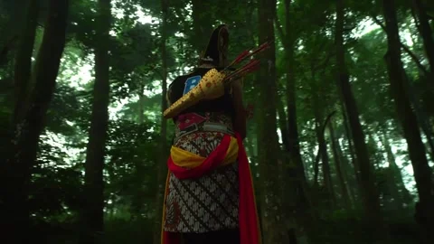 Javanese Traditional Warrior Dancer Walking in Tropical Forest Stock Footage 276348978
