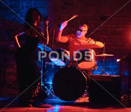 Jazz band performance. Couple of musicians - a drummer and a singer in a Stock Photos