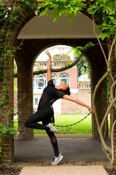 A jazz dancer performing under an arch Stock Photos