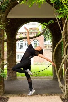 A jazz dancer performing under an archway Stock Photos