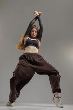 Jazz Funk Dancer Striking Dynamic Pose in Studio Showcasing Modern Urban Da.. Stock Photos