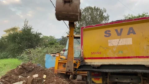 JCB 3CX tractor, wheel loader on road construction work loading dump truck Video stock 167700055