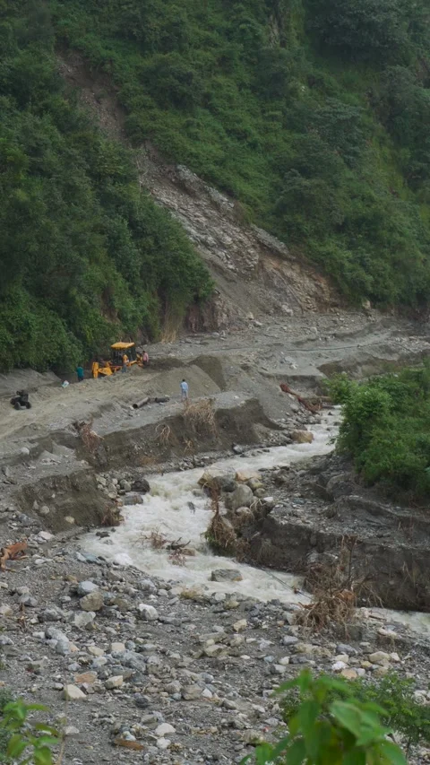 JCB backhoe loader clearing debris after cloudburst in Rajpur Dehradun Stock Footage 330230725