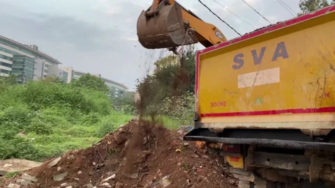 Jcb backhoe lodging dump truck Stock Footage 167699983