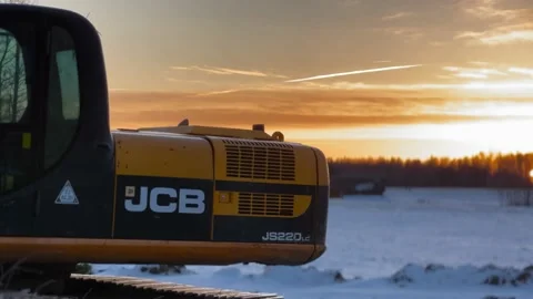 JCB excavator with a glorious sunset in the background in 4K Stock Footage 233021621