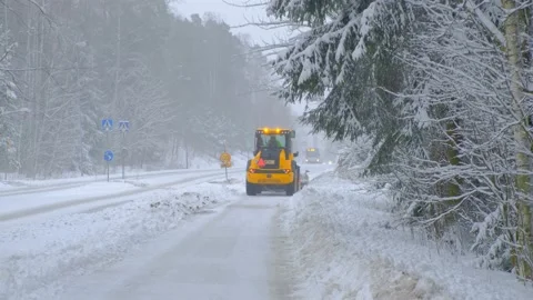 JCB tractor is clearing the street after a winter storm. Stock Footage 148091985