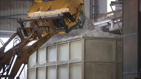 JCB is unloading a cotton seeds to cleaning in machine. Stock Footage 313931860