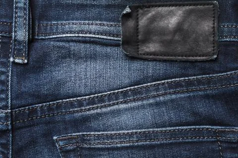 Jeans back side texture with black leather label Stock Photos
