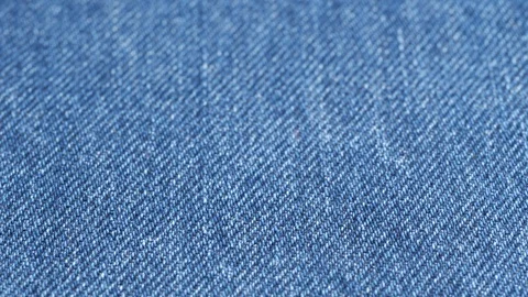 Jeans fabric plain surface background, low angle. Denim textile texture tracking Stock Footage 121375370