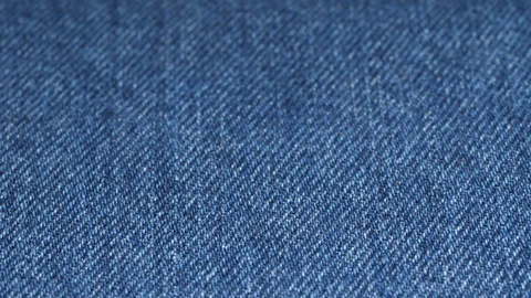Jeans fabric plain surface, low angle. Shallow DOF. Denim textile tracking Video stock 121375350