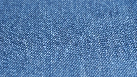 Jeans fabric plain surface tracking, low angle. Shallow DOF, focus at center Stock Footage 121375041