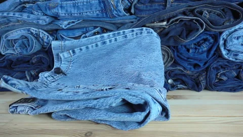 Jeans fall in slow motion onto a counter Video stock 212452610