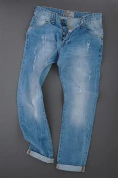 Jeans on grey background Stock Photos
