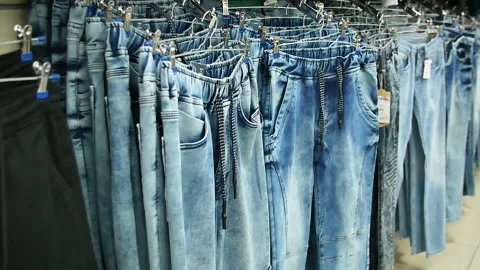 Jeans on the hanger in the store Stock Footage 95691885