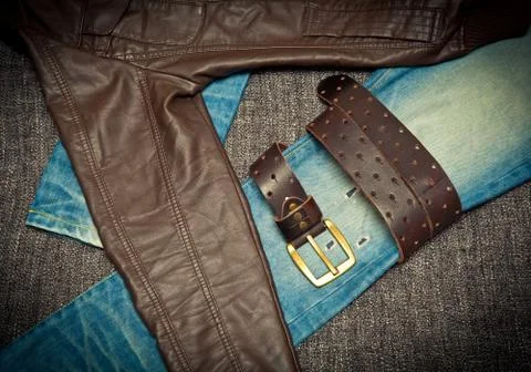 Jeans, leather jacket and a belt with a buckle Stock Photos