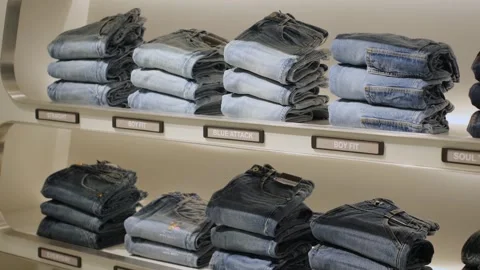 Jeans lie on a shop window, close-up 库存影片 254296013