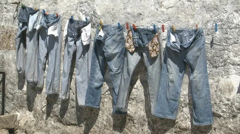 Jeans pants drying at sun Stock Footage 313399