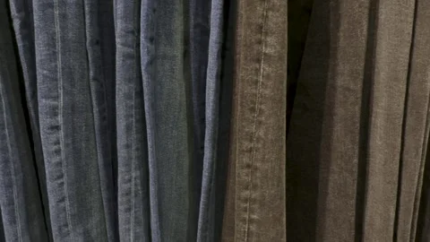 Jeans store. Lots of denim of different colors blue and black Stock Footage 294929115