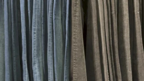 Jeans store. Lots of denim of different colors blue and black Stock Footage 294929135