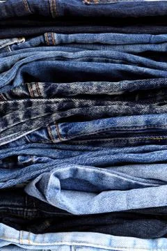 Jeans trousers stack closeup background texture Stock Photos