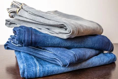 Jeans of various colors, folded. Stock Photos