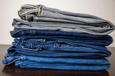 Jeans of various colors, folded. Stock Photos