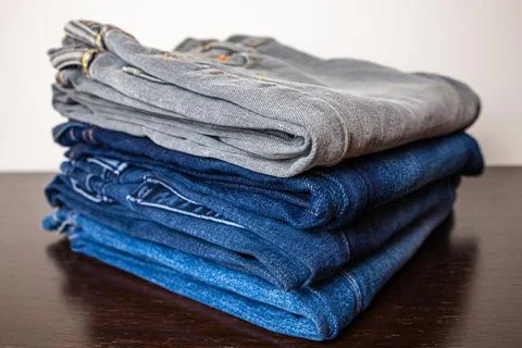 Jeans of various colors, folded. Stock Photos
