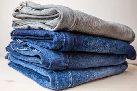 Jeans of various colors, folded. Stock Photos