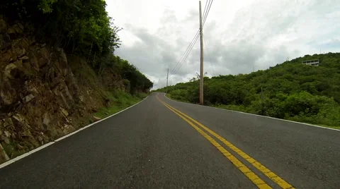 Jeep approaches a curve while in the Virgin Islands Video stock 41441051