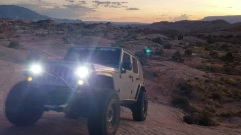 Jeep climb at night with mountain desert background Stock Footage