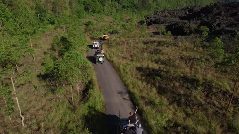Jeep Convoy Driving to Lava Fields at Mount Batur, Bali – Aerial View Stock Footage 313874732