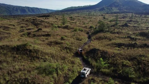 Jeep Convoy Driving to Lava Fields at Mount Batur, Bali – Aerial View Stock Footage 313877757