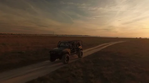 Jeep cruising on a beach trail Stock Footage 90673968