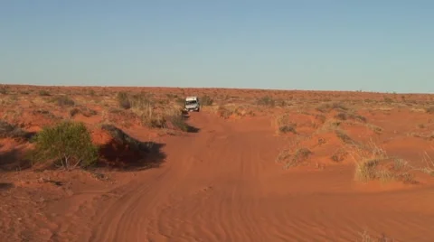 Jeep drive through sandy Simpson Desert over red sand dunes Stock Footage 56952995