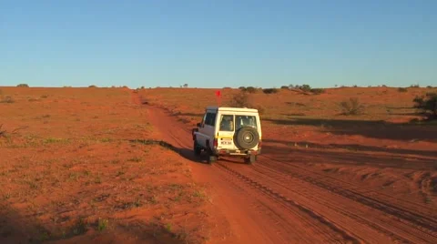 Jeep drive through sandy Simpson Desert over red sand dunes Stock Footage 56953036