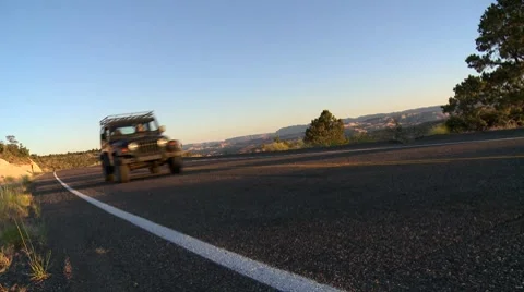 Jeep drives on desolate stretch of Utah road Stock Footage 8541036