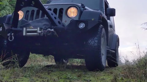 Jeep driving down grassy path - ground view Stock Footage 172563598