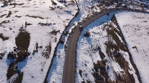 Jeep driving down a mountain in winter Stock Footage 158547900