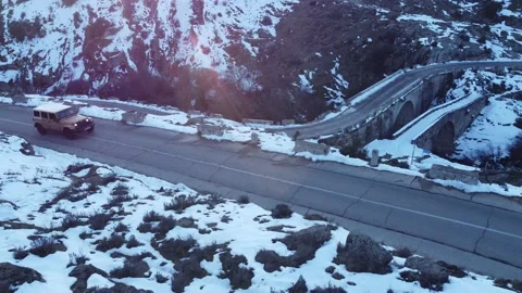 Jeep driving down a mountain in winter Stock Footage 158547901