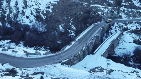 Jeep driving down a mountain in winter Stock Footage 158547906