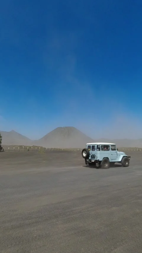 Jeep driving through the Bromo desert Stock Footage 236385172