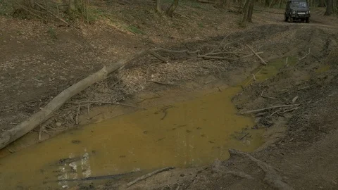 Jeep driving through a mud puddle Stock Footage 87390332
